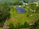 Aerial view of expansive property featuring lush greenery, screened pool, and mature trees at 20414 Quinn St, Orlando, FL 32833