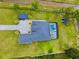 Aerial view of a beautiful home with a swimming pool, well-manicured lawn, and surrounding greenery at 20414 Quinn St, Orlando, FL 32833