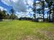 An expansive backyard features a well-manicured lawn with a screened in patio and a storage shed at 20414 Quinn St, Orlando, FL 32833