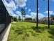 A large backyard features a pool with a screened-in enclosure and a manicured lawn at 20414 Quinn St, Orlando, FL 32833