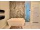 Sleek bathroom with modern soaking tub, glass shower, and decorative mosaic tile wall accent at 20414 Quinn St, Orlando, FL 32833
