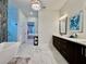 Bright bathroom featuring double vanity and glass-enclosed shower at 20414 Quinn St, Orlando, FL 32833