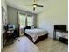 Well lit bedroom with neutral walls, tiled floors, a ceiling fan and multiple windows at 20414 Quinn St, Orlando, FL 32833