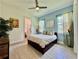 Bright bedroom featuring tile floors, natural light, and an ensuite bathroom at 20414 Quinn St, Orlando, FL 32833