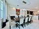 Elegant dining room with a modern chandelier and decorative brick wall at 20414 Quinn St, Orlando, FL 32833