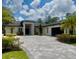 Elegant home exterior with well-maintained landscaping, a paved driveway, and a welcoming entrance at 20414 Quinn St, Orlando, FL 32833
