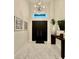 Bright foyer features marble floors, dark wood door and table, and modern light fixture at 20414 Quinn St, Orlando, FL 32833