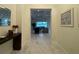 Bright foyer leads to an open concept living room with tray ceilings and modern furniture at 20414 Quinn St, Orlando, FL 32833