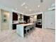 Modern kitchen boasts an oversized island with seating, stainless appliances, and tile flooring at 20414 Quinn St, Orlando, FL 32833