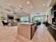 Kitchen with large island, prep sink, and stainless appliances open to the Gathering and dining rooms at 20414 Quinn St, Orlando, FL 32833