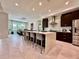 Bright open kitchen features a large island with seating, stainless steel appliances and a dining area at 20414 Quinn St, Orlando, FL 32833