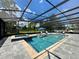 Outdoor screened pool and hot tub offers the perfect spot to unwind and relax with its serene atmosphere at 20414 Quinn St, Orlando, FL 32833