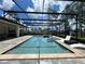 An inviting screened pool with hot tub, patio, yard and lush landscaping creates a relaxing outdoor oasis at 20414 Quinn St, Orlando, FL 32833