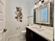 Elegant powder room featuring modern vanity, decorative mirror, and unique wall accents at 20414 Quinn St, Orlando, FL 32833