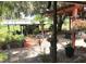 Beautiful backyard with outdoor kitchen, mature trees, landscaping, and covered patio at 2082 Starboard Dr, Geneva, FL 32732