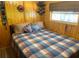 Charming bedroom with wood-paneled walls, a comfortable bed, and cozy decor at 2082 Starboard Dr, Geneva, FL 32732