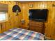 Bedroom with wood-paneled walls, a comfortable bed, and a flat-screen television at 2082 Starboard Dr, Geneva, FL 32732