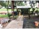 Outdoor boat house includes covered patio area with grill, washing machine, and stone path at 2082 Starboard Dr, Geneva, FL 32732