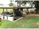 Boat lift with fishing boat is situated along the waterway behind the home at 2082 Starboard Dr, Geneva, FL 32732