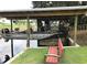 Well maintained boat lift with fishing boat is a great feature of this waterfront property at 2082 Starboard Dr, Geneva, FL 32732