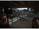 Waterfront deck featuring a dining area, mounted TV, ceiling fans, and peaceful views at 2082 Starboard Dr, Geneva, FL 32732