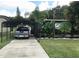 Long driveway with covered parking area, leading to the home and providing ample space at 2082 Starboard Dr, Geneva, FL 32732