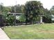 Charming home featuring mature trees and lawn, providing privacy and a serene setting at 2082 Starboard Dr, Geneva, FL 32732