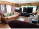 Cozy living room features comfortable seating, wood-paneled walls, and nautical-themed decorations at 2082 Starboard Dr, Geneva, FL 32732
