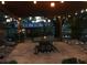Cozy outdoor patio featuring a stone fire pit, covered pergola with string lights, and view of the waterfront at 2082 Starboard Dr, Geneva, FL 32732