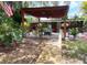 Inviting patio with pergola and outdoor grill, surrounded by lush landscaping and an American flag at 2082 Starboard Dr, Geneva, FL 32732