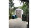 Practical storage shed on a concrete pad, accompanied by trash and recycling containers at 2082 Starboard Dr, Geneva, FL 32732