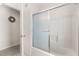 Bathroom with shower featuring sliding glass doors and white tiled floor at 2263 Mallory Cir, Haines City, FL 33844