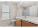 A bathroom with a window, a single sink vanity, and a shower with sliding glass doors at 2263 Mallory Cir, Haines City, FL 33844