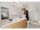 A primary bathroom with a dual sink vanity and a walk-in shower at 2263 Mallory Cir, Haines City, FL 33844