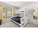 ' bedroom with a white bunk bed near a window with bright yellow curtains at 2263 Mallory Cir, Haines City, FL 33844