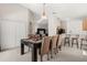 Open-concept dining area with a billiard table, light fixture, breakfast bar, and easy kitchen access at 2263 Mallory Cir, Haines City, FL 33844