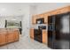 Efficient kitchen featuring stainless steel appliances, bright wood cabinets, and an open view to dining area at 2263 Mallory Cir, Haines City, FL 33844