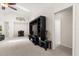 Spacious living room featuring neutral carpet, high ceiling with skylight, and modern entertainment center at 2263 Mallory Cir, Haines City, FL 33844