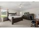 A primary bedroom with a ceiling fan, carpeted floor, and a window at 2263 Mallory Cir, Haines City, FL 33844