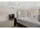 A primary bedroom with carpeted floors, ceiling fan, and a sliding glass door at 2263 Mallory Cir, Haines City, FL 33844