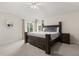A main bedroom featuring carpeted floors, a ceiling fan, and a window at 2263 Mallory Cir, Haines City, FL 33844