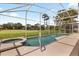 Screened in pool and jacuzzi with a view of the green yard at 2263 Mallory Cir, Haines City, FL 33844