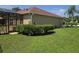 Well-maintained backyard with lush lawn and mature hedges, perfect for outdoor enjoyment at 2357 Great Harbor Dr, Kissimmee, FL 34746