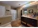 Bathroom with shower, vanity, wood look tiled floors and separate tub area, providing a relaxing space at 2357 Great Harbor Dr, Kissimmee, FL 34746