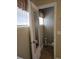 Powder room with wood-look tile, neutral paint, framed mirror and window with blinds at 2357 Great Harbor Dr, Kissimmee, FL 34746
