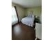 Bedroom with a full-sized bed, a side table with lamps, and a large window, creating a peaceful retreat at 2357 Great Harbor Dr, Kissimmee, FL 34746