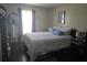 A cozy bedroom with a comfortable queen bed, a decorative mirror, and soft natural light at 2357 Great Harbor Dr, Kissimmee, FL 34746