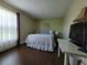 Cozy bedroom with natural light, featuring a full bed and comfortable desk area for a peaceful atmosphere at 2357 Great Harbor Dr, Kissimmee, FL 34746