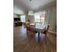 Well-lit dining room featuring tile floors, table with seating for six, and views of the yard at 2357 Great Harbor Dr, Kissimmee, FL 34746