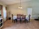 Traditional dining room with wood-look tile floors, a chandelier, and seating for six people at 2357 Great Harbor Dr, Kissimmee, FL 34746